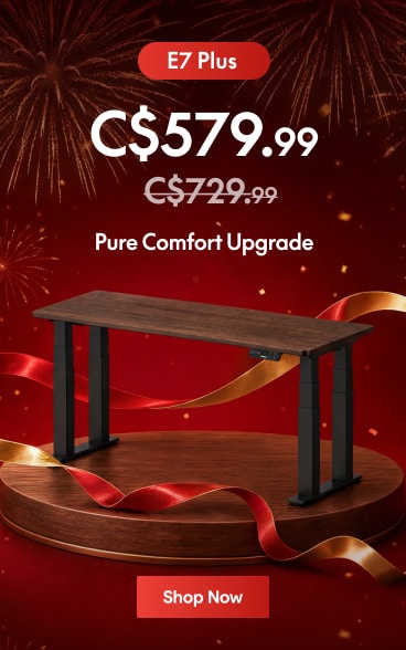 E7 Plus adjustable standing desk with a dark wood finish and black legs, priced at C$579.99, discounted from C$729.99.