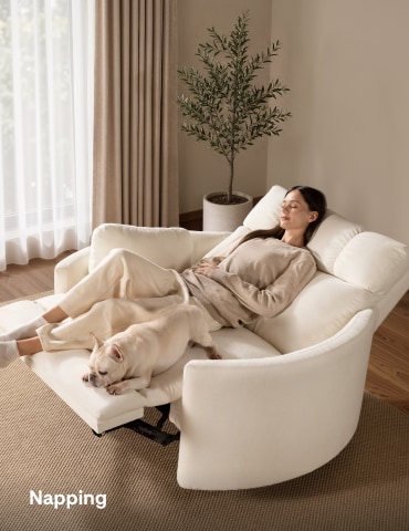 Woman taking a relaxing nap on a fully reclined oversized power recliner chair