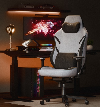 A GC7 gaming chair in front view in a warm-lit gaming station