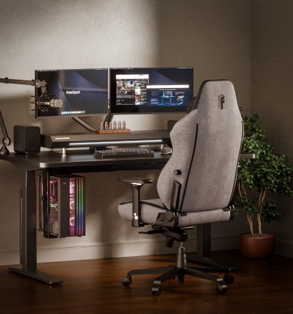 A GC7 gaming chair in back view in a dual-monitor home office