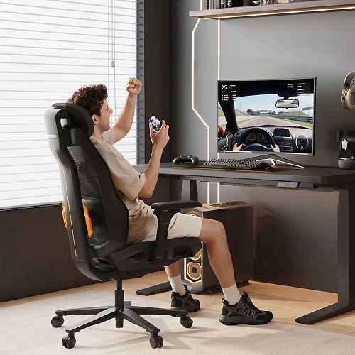 A man celebrating a win while playing games on the Wingo chair in a bright gaming room