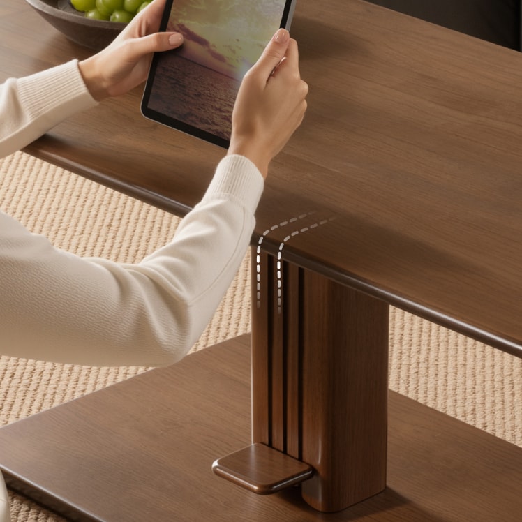 Woman using a tablet beside the gently curved arm-friendly tabletop edge