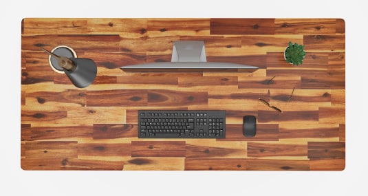 Top-down view of finger-jointed acacia wood desktop showing distinctive natural grain with unique knots on every tabletop