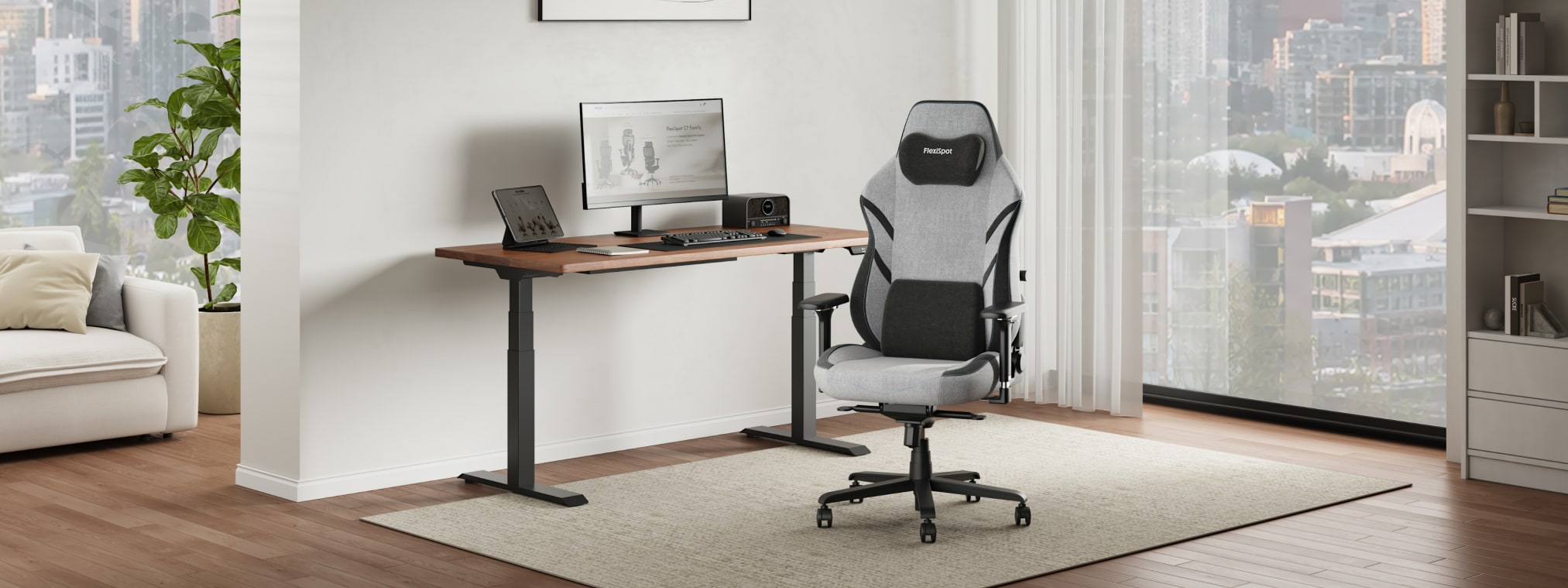 The GC7 ergonomic gaming chair is placed at a standing desk in a bright, modern home office.