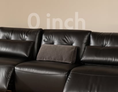Zero-wall power reclining sofa fully reclined with minimal clearance from the wall