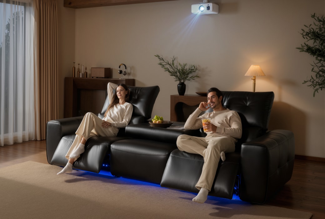 Family watching a movie on a reclining sofa with speakers, bass vibration, and ambient lighting