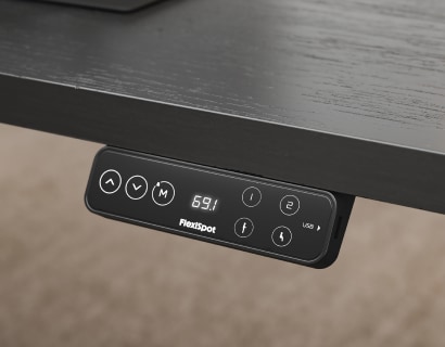 Standing desk hand controller close‑up, LED display, height memory presets, USB ports for smooth electric adjustment